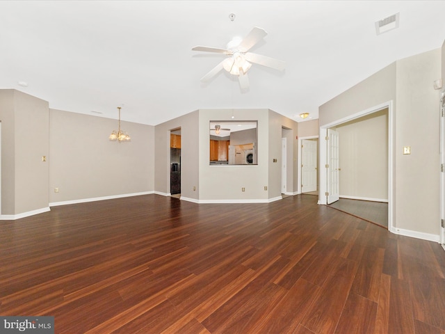 unfurnished living room featuring a chandelier, wood finished floors, baseboards, and ceiling fan