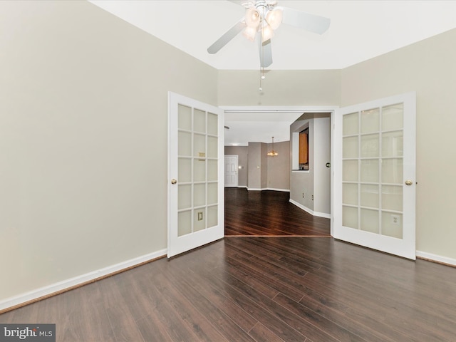 empty room with ceiling fan, wood finished floors, baseboards, french doors, and built in shelves