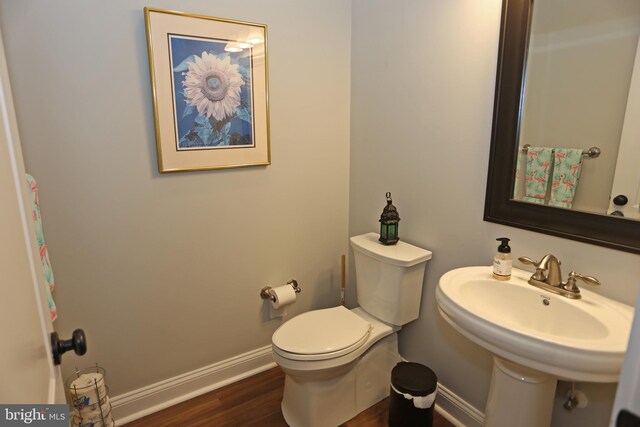 168 Williams Way, Lewes, DE 19958 - bathroom featuring baseboards, wood finished floors, toilet, and a sink