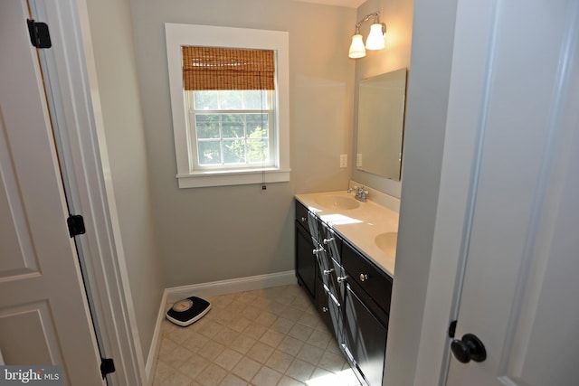 168 Williams Way, Lewes, DE 19958 - bathroom with double vanity, baseboards, and tile patterned floors