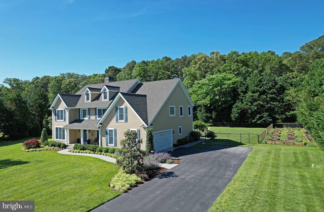 168 Williams Way, Lewes, DE 19958 - view of front of property with asphalt driveway, an attached garage, a view of trees, and a shingled roof