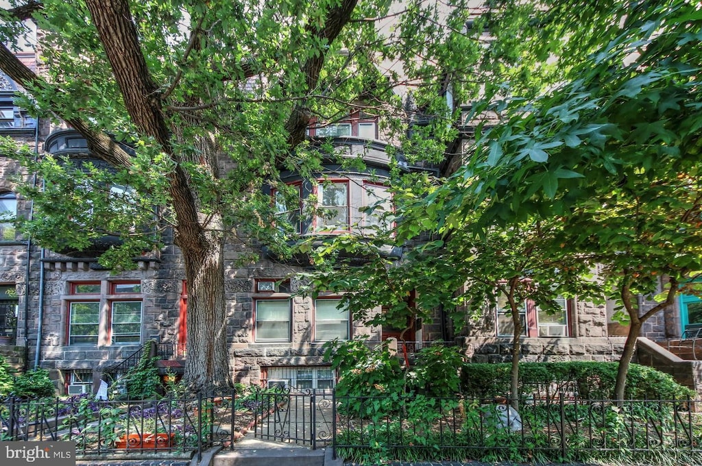 view of front of property featuring a fenced front yard and stone siding