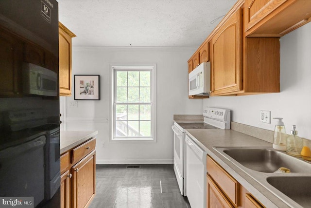 144 Falcon Trl, Winchester, VA 22602 - kitchen with white appliances, a sink, dark wood-type flooring, crown molding, and baseboards