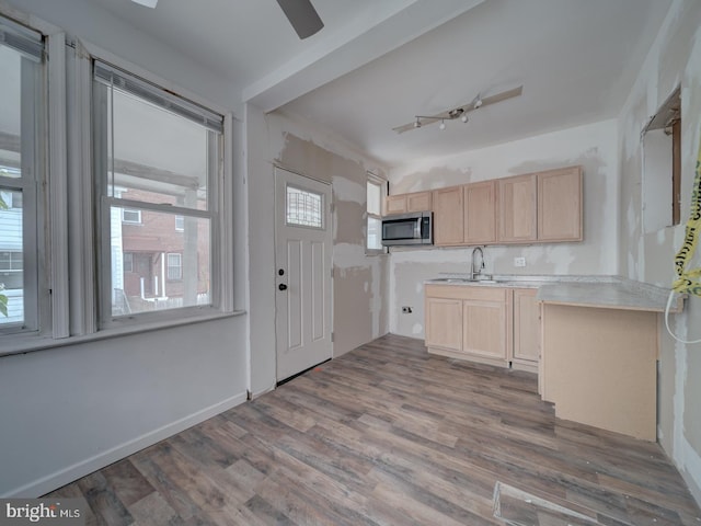 820 Tuckerman St NW, Washington, DC 20011 - kitchen featuring light brown cabinetry, stainless steel microwave, wood finished floors, light countertops, and ceiling fan