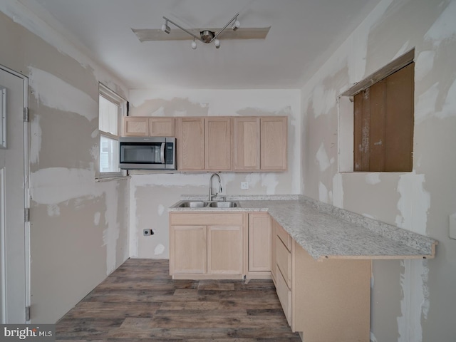 820 Tuckerman St NW, Washington, DC 20011 - kitchen featuring stainless steel microwave, light brown cabinetry, dark wood finished floors, and light countertops