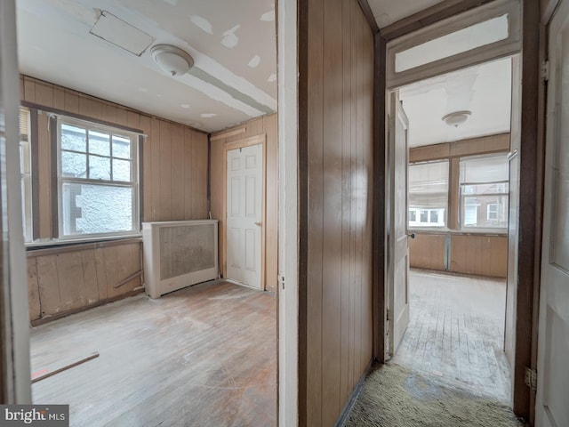 820 Tuckerman St NW, Washington, DC 20011 - corridor featuring wooden walls, light wood-type flooring, and radiator heating unit