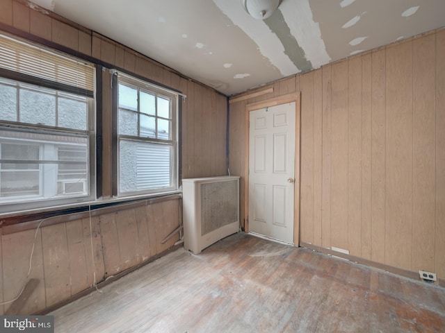 820 Tuckerman St NW, Washington, DC 20011 - empty room featuring wood finished floors, wood walls, and radiator
