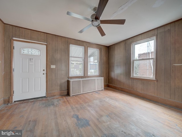 820 Tuckerman St NW, Washington, DC 20011 - foyer entrance featuring radiator heating unit, ceiling fan, wood-type flooring, and wood walls