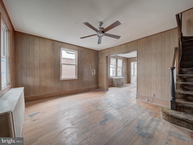 820 Tuckerman St NW, Washington, DC 20011 - spare room featuring stairs, hardwood / wood-style flooring, ceiling fan, and wooden walls