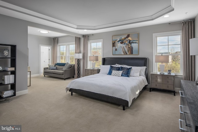 bedroom featuring light colored carpet, a tray ceiling, multiple windows, recessed lighting, and baseboards