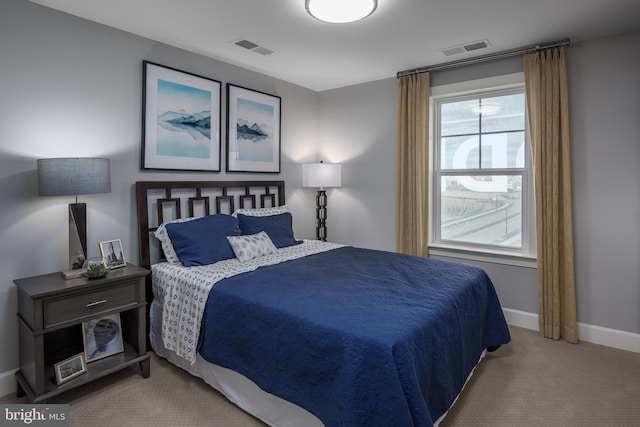 carpeted bedroom featuring baseboards