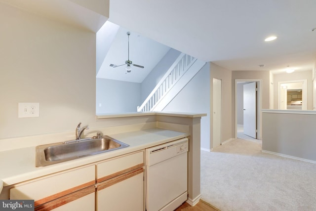 kitchen featuring white dishwasher, a sink, light carpet, baseboards, and light countertops