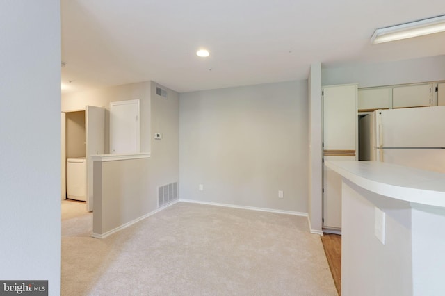 spare room featuring light carpet, baseboards, and recessed lighting
