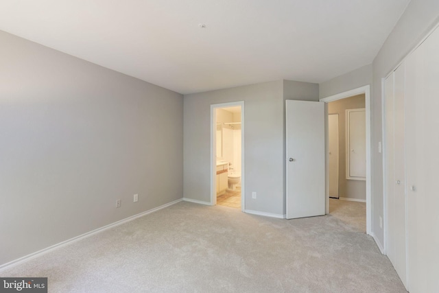 unfurnished bedroom with light colored carpet, baseboards, and a closet