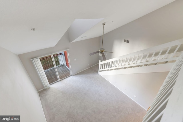 unfurnished living room featuring carpet floors, vaulted ceiling, a ceiling fan, and baseboards