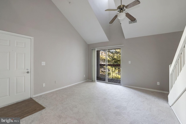 unfurnished living room with high vaulted ceiling, carpet, a ceiling fan, and baseboards