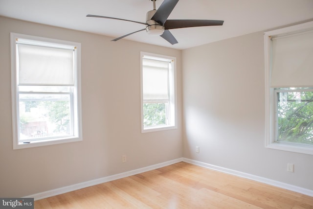 5519 Minnoka Ave, Baltimore, MD 21215 - spare room with wood finished floors, a ceiling fan, and baseboards