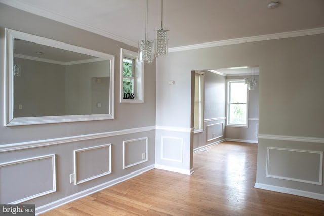 5519 Minnoka Ave, Baltimore, MD 21215 - unfurnished dining area with a chandelier, wood finished floors, ornamental molding, and a decorative wall