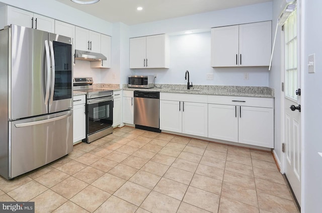 2012 All Hallows Ct, Waldorf, MD 20602 - kitchen with stainless steel appliances, under cabinet range hood, a sink, white cabinets, and light stone countertops