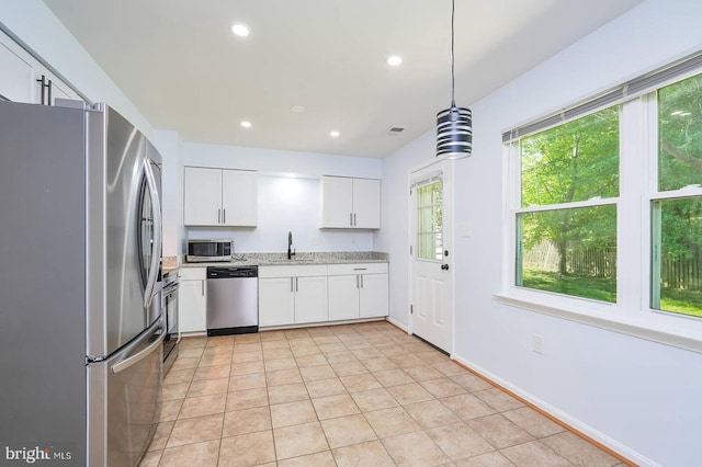 2012 All Hallows Ct, Waldorf, MD 20602 - kitchen with appliances with stainless steel finishes, white cabinetry, light tile patterned floors, light stone countertops, and a sink