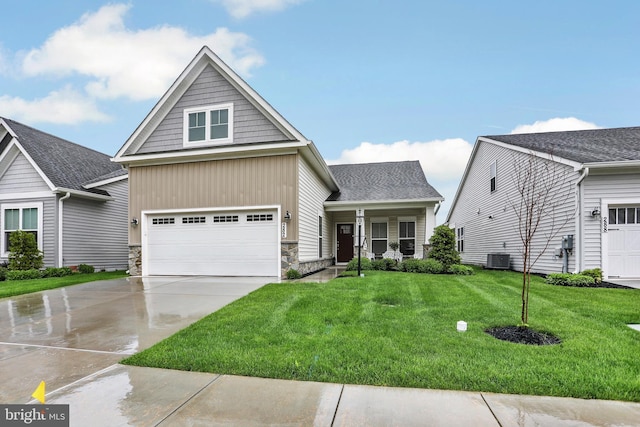 view of front of house with driveway, stone siding, a garage, a front lawn, and central AC unit