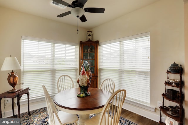 dining room featuring a ceiling fan, wood finished floors, and baseboards