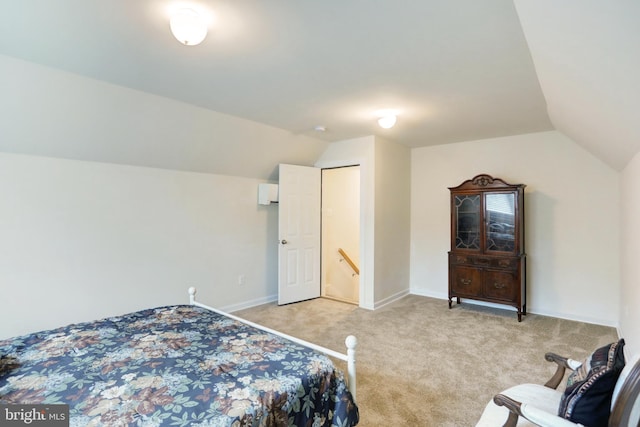 bedroom with lofted ceiling, light colored carpet, and baseboards