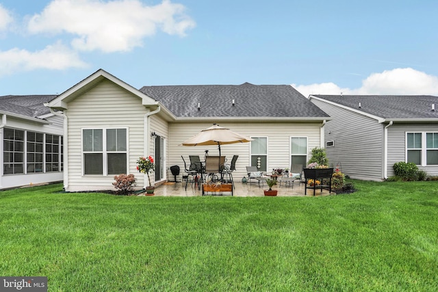back of house with a patio and a yard