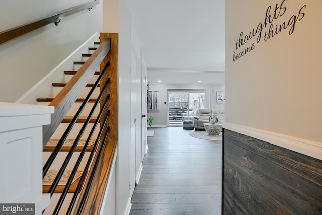 stairway with wood finished floors and recessed lighting