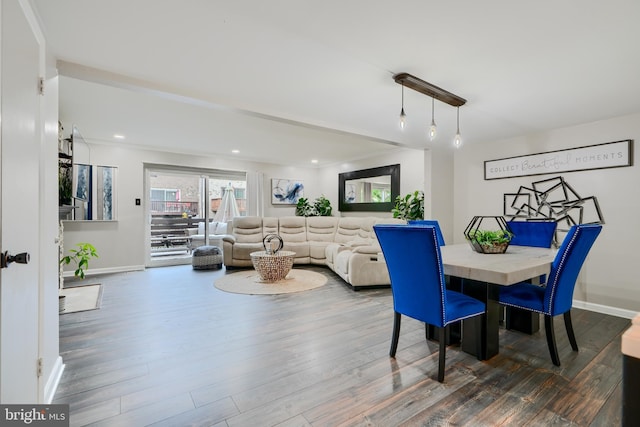 dining space with baseboards, wood finished floors, and recessed lighting
