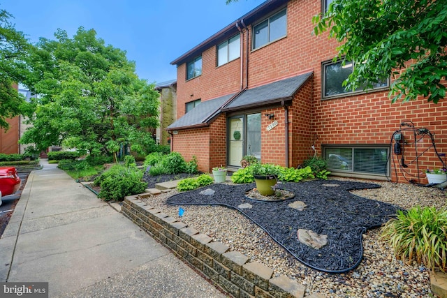 doorway to property with brick siding