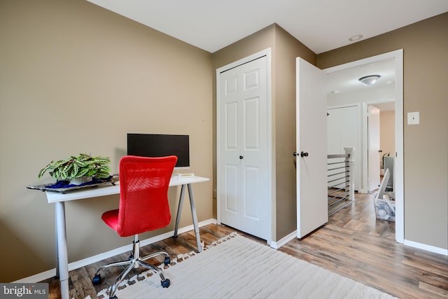office space with wood finished floors and baseboards