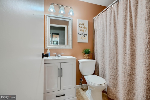 bathroom featuring toilet and vanity