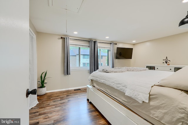 bedroom featuring attic access, dark wood-style flooring, baseboards, and recessed lighting