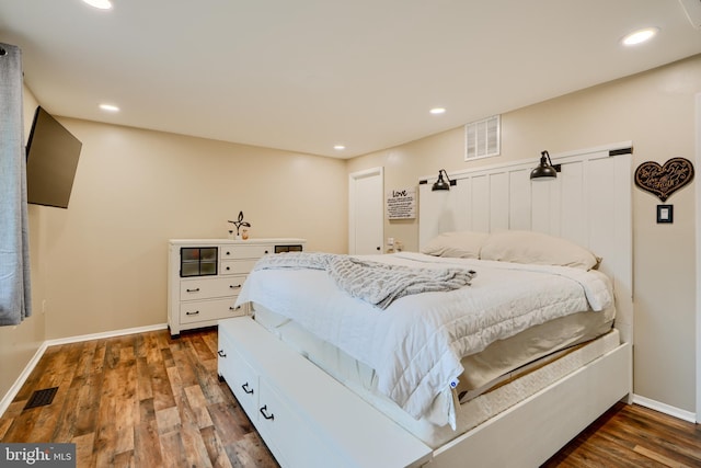 bedroom with baseboards, dark wood-type flooring, and recessed lighting