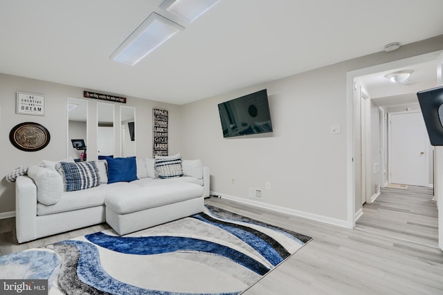 living room with light wood-style floors and baseboards