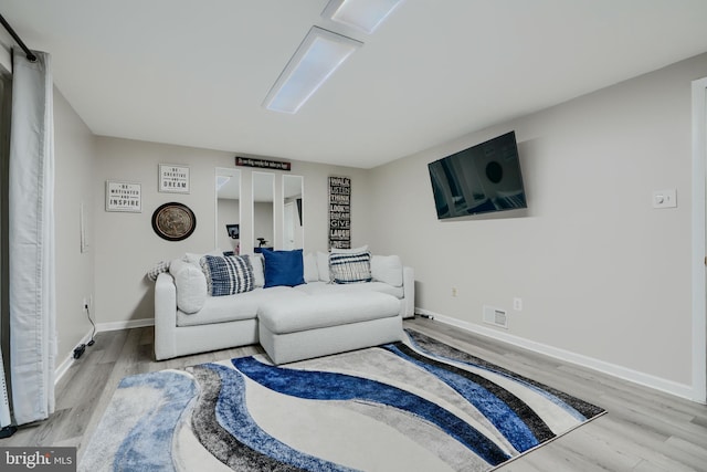 living room featuring wood finished floors and baseboards