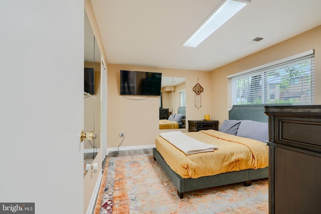 bedroom featuring baseboards and wood finished floors