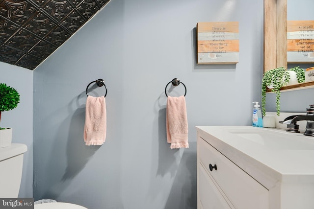 bathroom with toilet and vanity