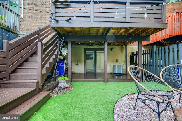 rear view of property featuring central air condition unit, stairs, and brick siding