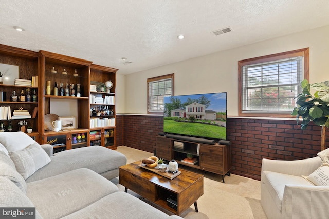 12821 Flagship Ave, Herndon, VA 20170 - living room with brick wall, a wainscoted wall, and a textured ceiling