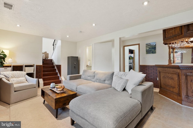 12821 Flagship Ave, Herndon, VA 20170 - living room with recessed lighting, stairway, a textured ceiling, a dry bar, and light tile patterned flooring