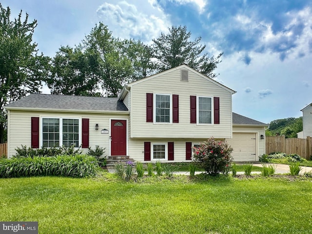 tri-level home with a garage and concrete driveway