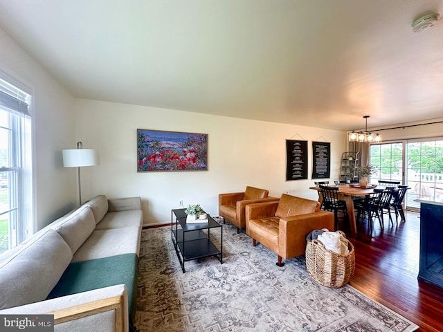 living area with a chandelier and wood finished floors