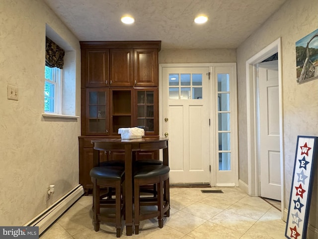615 Bryn Mawr Ave, Penn Valley, PA 19072 - dining space featuring baseboard heating, a textured wall, light tile patterned floors, and recessed lighting