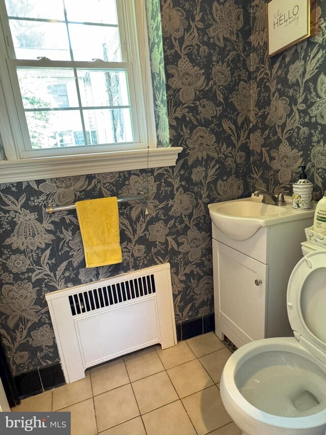 615 Bryn Mawr Ave, Penn Valley, PA 19072 - half bath with radiator heating unit, wallpapered walls, tile patterned floors, vanity, and toilet