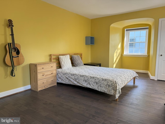 615 Bryn Mawr Ave, Penn Valley, PA 19072 - bedroom with baseboards, dark wood-style floors, and arched walkways