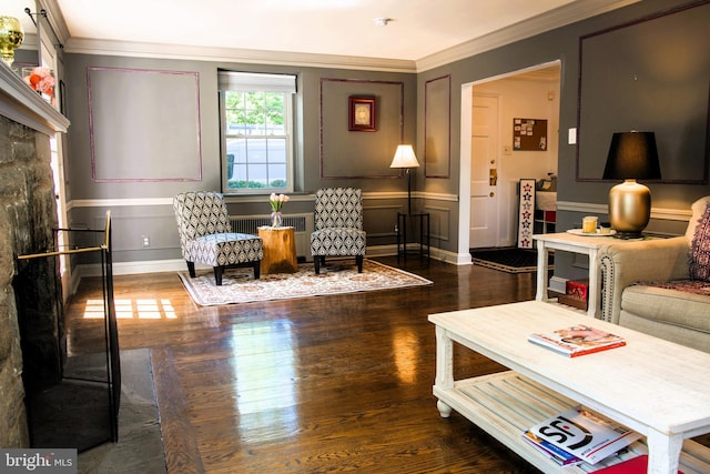 615 Bryn Mawr Ave, Penn Valley, PA 19072 - living room featuring radiator heating unit, crown molding, dark wood-style floors, a decorative wall, and baseboards