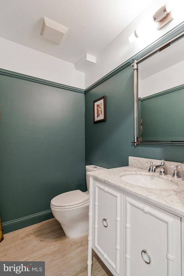 8412 Riverside Rd, Alexandria, VA 22308 - bathroom with wood finished floors, vanity, and toilet