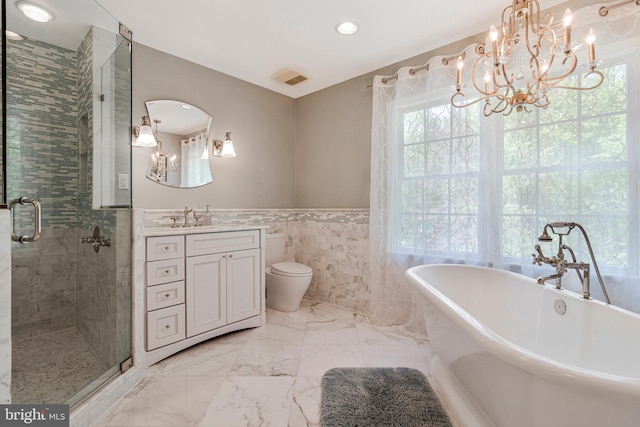 8412 Riverside Rd, Alexandria, VA 22308 - bathroom featuring a chandelier, healthy amount of natural light, vanity, wainscoting, and tile walls